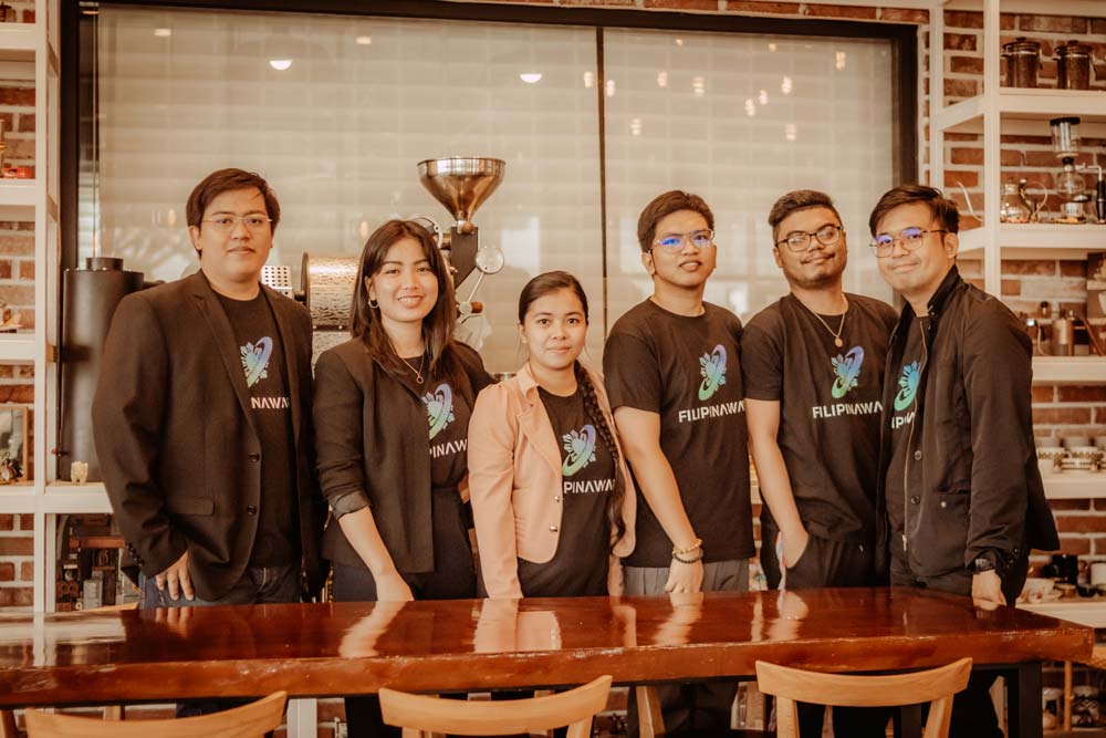 A group photo of employees standing behind the table